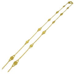 A. CIPULLO long chain link necklace composed of gold screws.