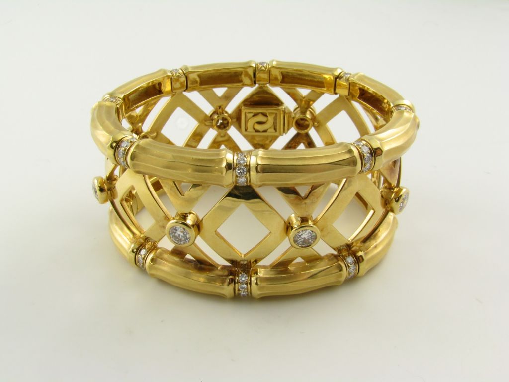 An 18 karat yellow gold and diamond bamboo motif bracelet.  Cartier serial number 710731.
