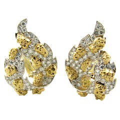 A chic pair of platinum, diamond and yellow gold earrings.