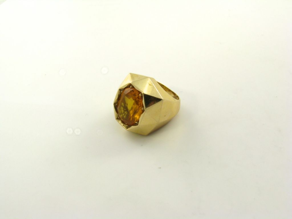 A fabulous oval shaped faceted citrine and gold dome shaped ring