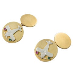Vintage A whimsical pair of platinum, ruby, emerald and gold cufflinks.