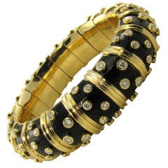 TIFFANY SCHLUMBERGER classic gold, enamel and diamond bangle.