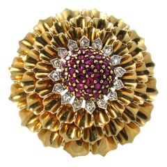 A  yellow gold, ruby and diamond "zinnia" brooch.
