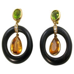 A chic pair of wood, peridot, diamond and yellow gold earrings.