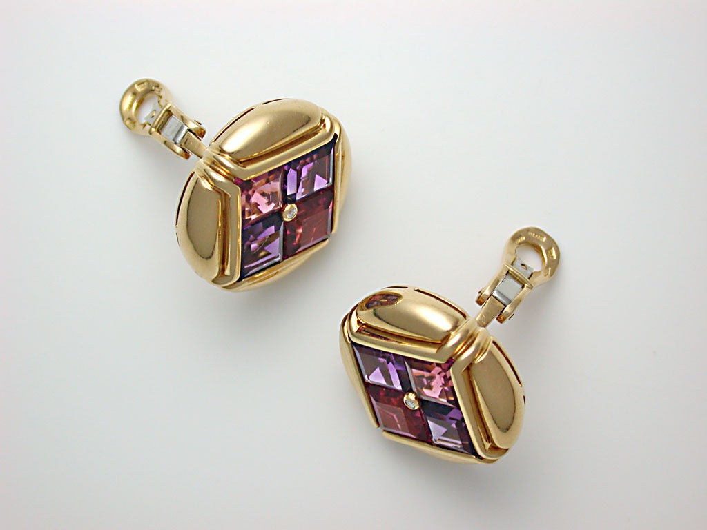 The polished yellow gold buttons surrounding diamond-shaped clusters of square-cut pink tourmaline and amethyst, with diamond centers, sturdy clip backs (posts can easily be added), signed BVLGARI, stamped 750 for 18kt gold and Made in Italy, ca.