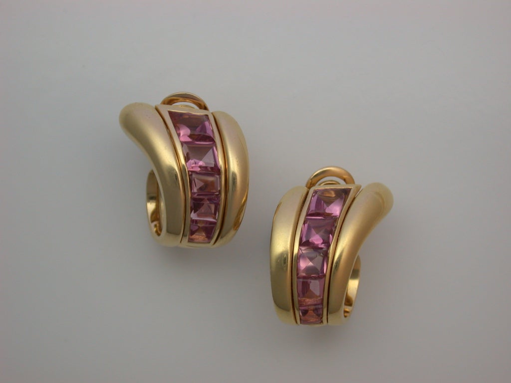 An illusion hoop, the sweeping polished rose gold arcs set down the centers and up the backs with invisibly-set buff-top pale pink tourmalines (16 stones weighing approximately 6 carats total), sturdy clip backs and twisted rope pads for grip,