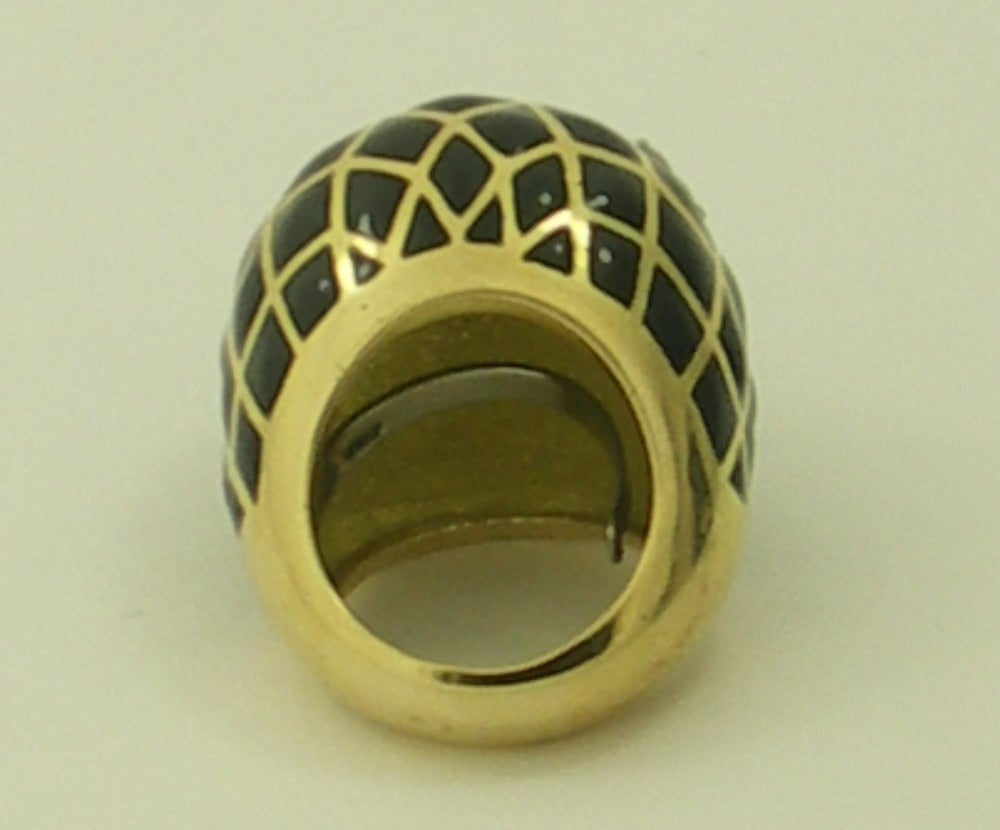 Constructed of 18K yellow gold, this beautiful David Webb ring features diamond shaped cells of black enamel, which contrast dramatically with it's round brilliant cut diamonds. The dome itself rises 3/4 of an inch above the finger. Adding