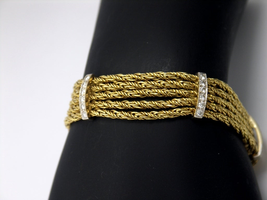 Tiffany & Co. 18K Yellow Gold 5 strand, tinsel bracelet with 5 diamond stations. Each station is set with 6 round brilliant cut diamonds for a total approximate weight of 1.00CT. An easy to wear, every day bracelet, that goes day to night. The