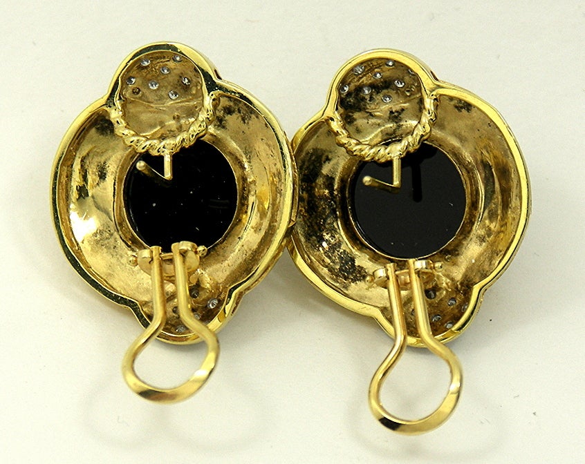 Ideal for work or for going out to lunch or dinner, these tailored, 14K Yellow Gold button earrings are set with 2 round onyx cabochons and with diamonds weighing approximately .50CT total of overall G color and SI1 clarity. These earring come with