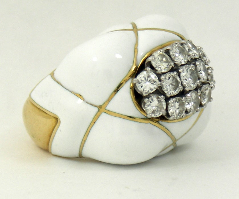 Great looking David Webb white enamel and diamond ring.
Set with 13 round brilliant cut diamonds weighing approximately
2.35CT total of overall G color VS1 clarity. Measures 1 3/16