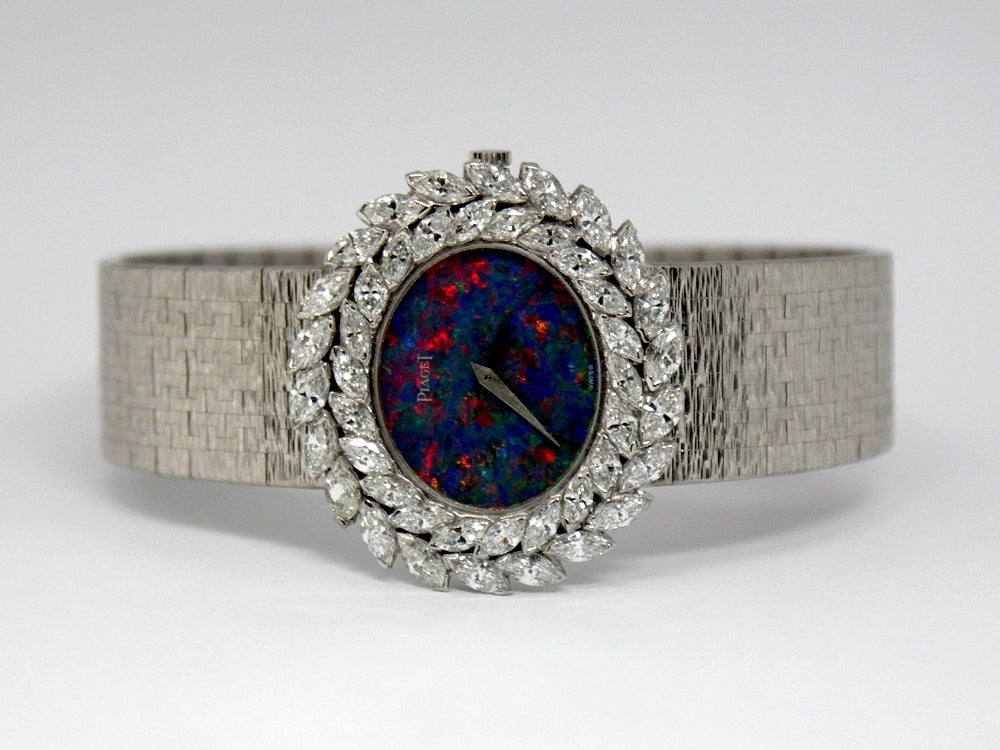 Outstanding is the word for this 1970s lady's Piaget bracelet watch. The dramatic opal dial is surrounded two rows of white, brilliant marquise diamonds weighing an approximate total of 6.50ct. This 18k white gold beauty
weighs a hefty 81.7grams
