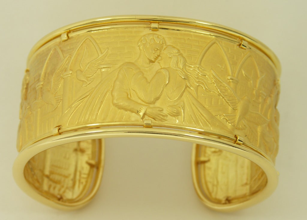 One ladies 18K yellow gold cuff bracelet by Carrera y Carrera, beautifully demonstrating their signature use of a variety of finishes to create artistic scenes in their pieces. This bracelet uses three different depictions of the 