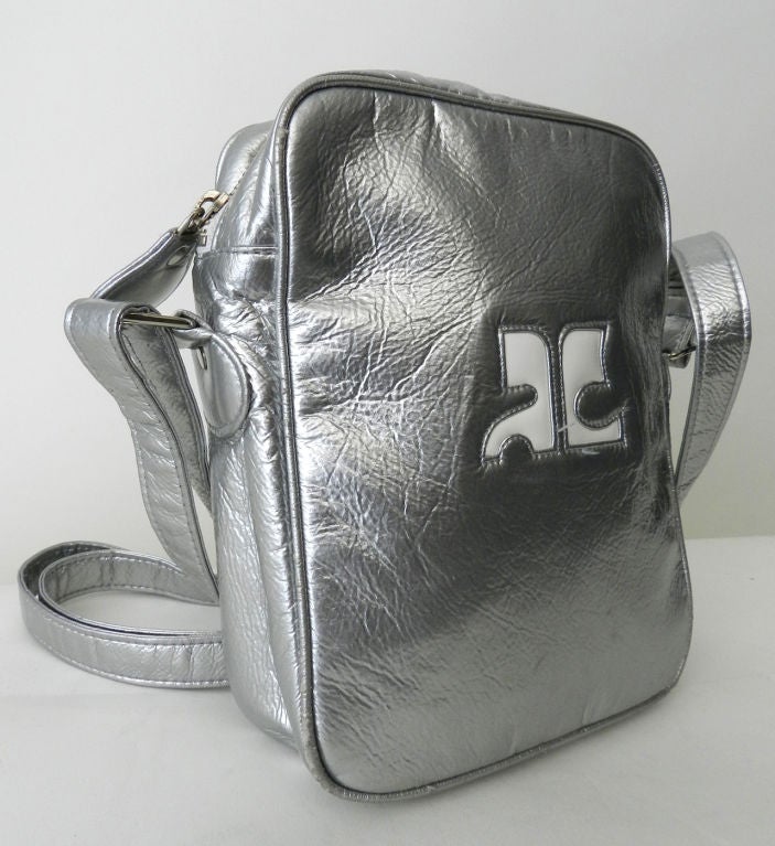 Vintage Courreges space-age design silver purse. Metal zip top with long adjustable cross-body strap.  Silver PVC vinyl material.  <br />
<br />
Measurements:<br />
height 8
