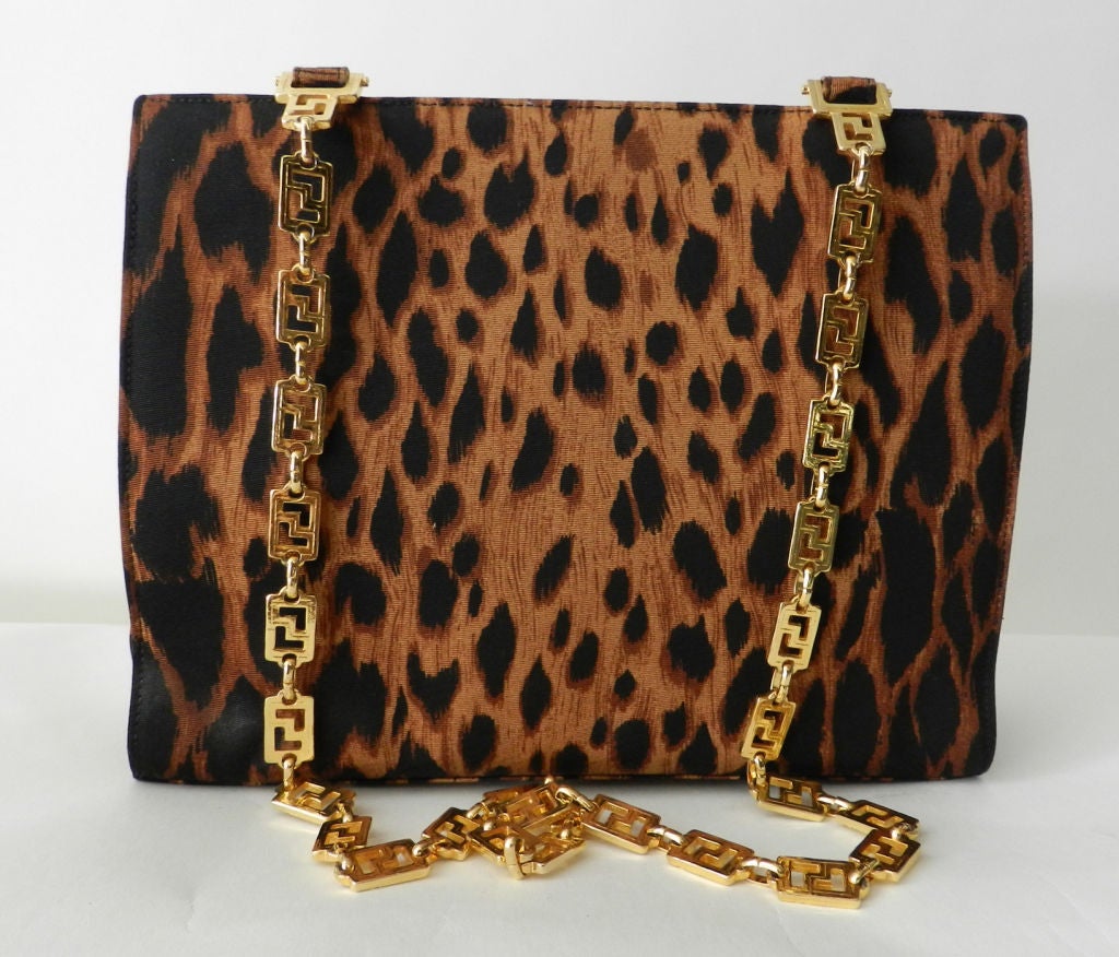 Gianni Versace Couture iconic leopard pattern fabric purse with large gold medusa head.  Heavy double goldtone metal Greek key chain straps, metal zipper with medusa head pull, and eight medusa head studs on front.  Excellent vintage condition with