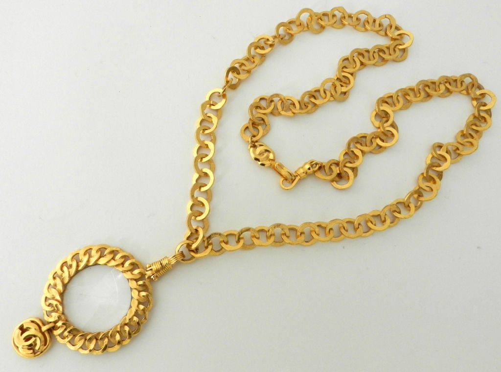Chanel 1996 P chain necklace with magnifying glass pendant.  Brushed goldtone metal and fastens with hook closure. Excellent previously owned condition.
