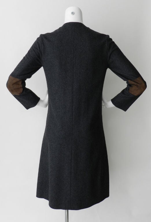 Classic older vintage Hermes dress circa 1960's. Fabric is charcoal grey wool with brown suede snap buttons, elbow patches, and waist. Suede is decorated with top stitched design and garment is fully lined with black acetate. Excellent vintage