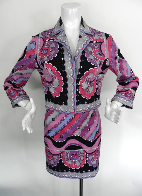 Vintage 1970's Emilio Pucci Crop jacket and matching skirt suit. Cotton fabric with vibrant Pucci border print in black, white, pink, and purple. Mini skirt has side zipper and jacket fastens with 3 hidden button at front. Excellent strong condition
