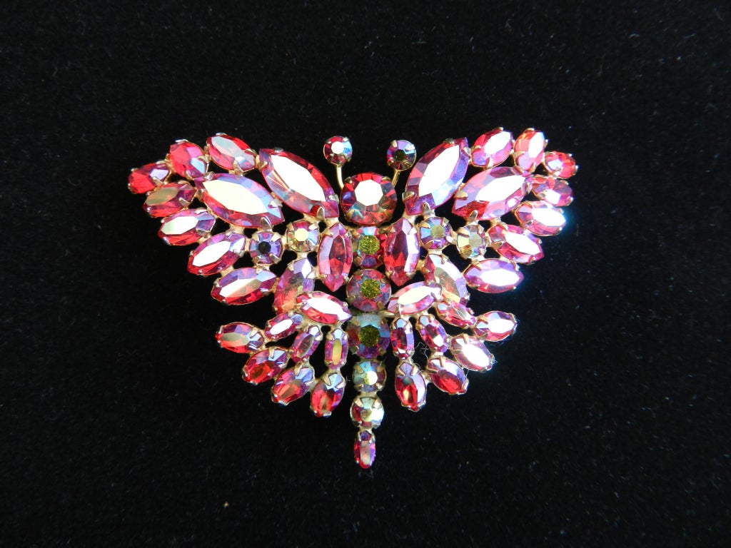 Sherman fuchsia aurora borealis rhinestone butterfly brooch. Goldtone metal setting. Excellent vintage condition. Signed Sherman on reverse.