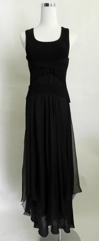 Jean Paul Gaultier black dress. Comes in 3 parts. Black silk jersey strappy tube dress is worn first. Then overdress with stretch rib jersey bodice and sheer silk chiffon skirt is worn over. Then the corset/belt. 90% viscose / 10% nylon.
 