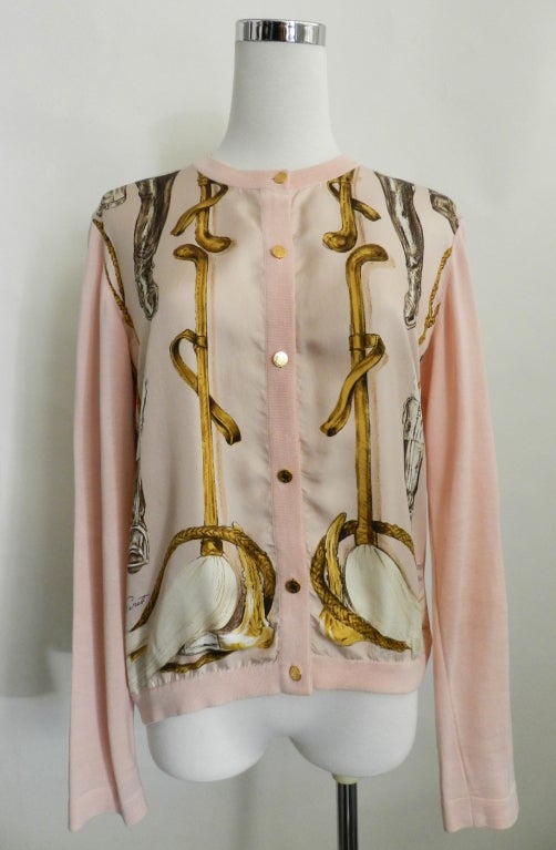 Vintage Hermes cardigan sweater with pink silk scarf front. Pink polished cotton knit body with silk front and gold metal logo buttons.  

Measurements:
tagged size 38
recommended for bust 34/36