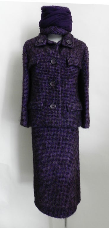 Vintage 1960's Christian Dior skirt and jacket suit with matching hat. Heavy purple tweed wool, lined in silk, fastens with 3 large buttons at front, and two at collar.

Measurements:
approx. size 10
skirt waist 30