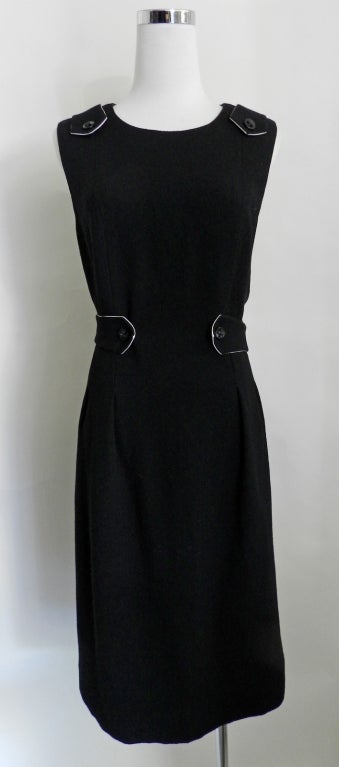 Chanel 06A black sleeveless wool dress.  Dress zippers up centre back, and has black jewelled buttons.  Belt, shoulders, and interior skirt are lined in white silk satin.  Excellent never worn condition. 100% wool. 

Measurements:
Tagged size