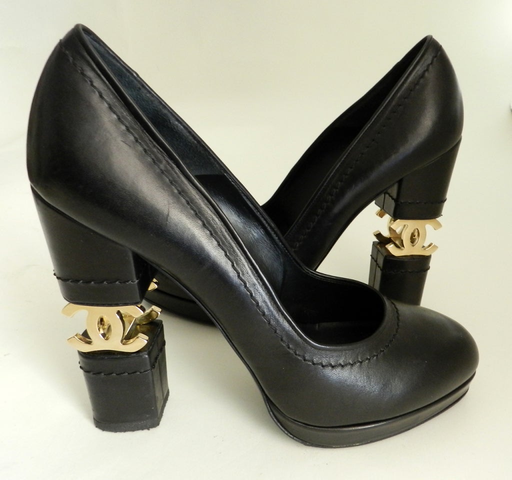 Chanel CC logo charm platform heel. Black leather, gold CC heel detail, rubberized sole.  Excellent gently previously owned condition. Size 41.