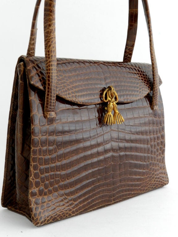 Vintage 1960's brown alligator skin purse.  Small evening size with goldtone tassel clasp.  High end purse labelled 