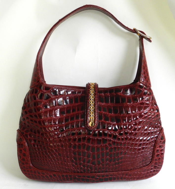 Gucci vintage circa 1970's Jackie O bag purse in red alligator.  Goldtone metal hardware, small zippered pocket inside, and signed Gucci on underside of handle.  Excellent vintage condition. Body measures 13 x 8.5