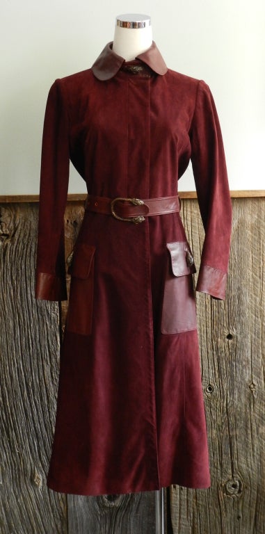 Gucci vintage 1970's suede coat. Dark burgundy bordeaux colour with leather collar, cuffs, pockets and belt.  Interior is lined with silk GG horsebit logo fabric, and there are sterling and red enamel tiger heads at front pockets, neck, and belt