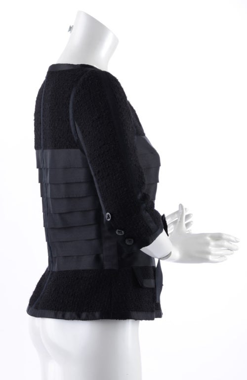 Chanel 06A black wool and satin runway jacket. Zippers up centre front, has 3/4 length sleeves, black rhinestone buttons, and silk satin sash belt.  Tagged size Chanel 38. Excellent condition - worn once.  Bust to fit 34