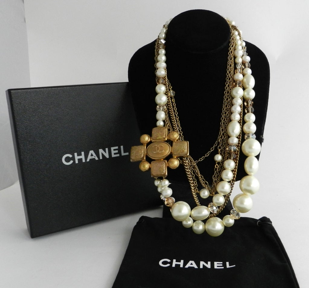 Chanel 2007A multi-strand necklace in box. Large gold gripoix logo cross, crystal and pearl beaded double strand, and matte goldtone metal chains. Longest strand is 26