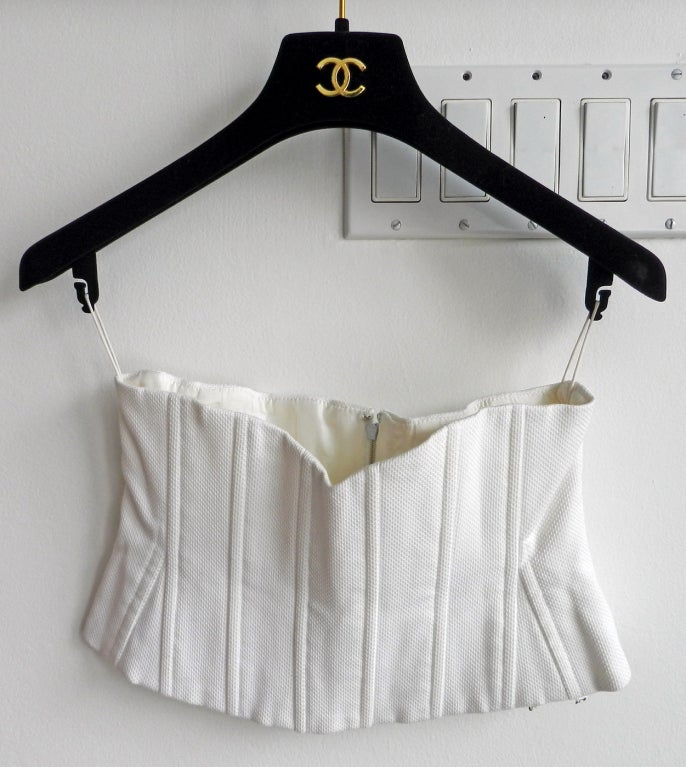 Chanel 1994 spring white cotton corset or waist cincher. These were shown on the runway worn under the classic Chanel jackets. Material is waffle textured cotton, fastens with metal zipper at back, and is lined with white CC jacquard silk.  Tagged