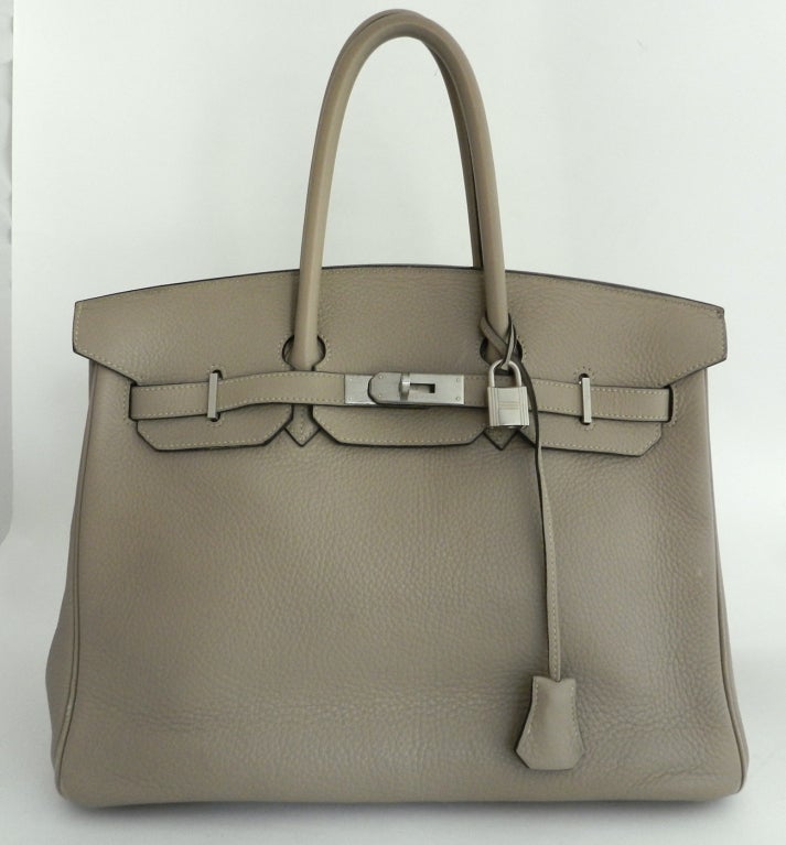 Hermes Birkin bag 35cm in Etoupe colour and Clemence leather. Brushed palladium hardware. Date stamp D in a square and 33 for year 2000.  Comes with lock, key, clochette, orange Hermes box, dustbag, clochette bag, raincoat, care card. In good