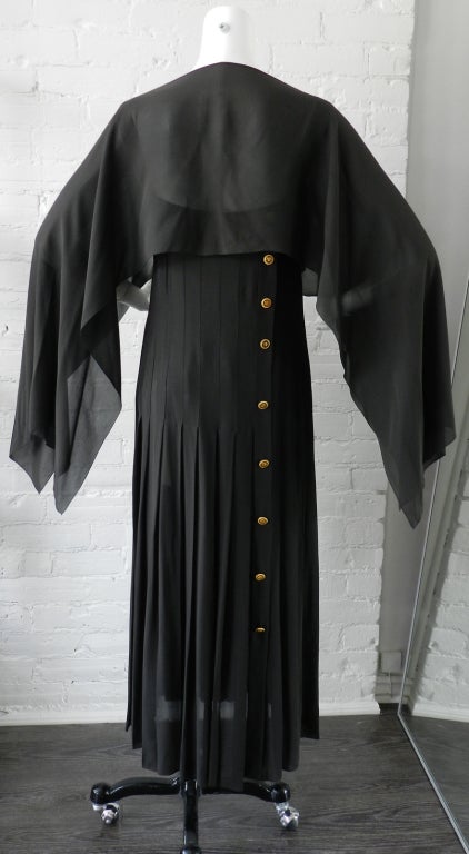 Chanel vintage 1989/1990 winter black silk dress and matching shawl.  Dress is a straight-cut loose-fitting pleated column dress with gold coco chanel profile buttons down side back.  Colour is a dark slate greyish black. Excellent condition. 
