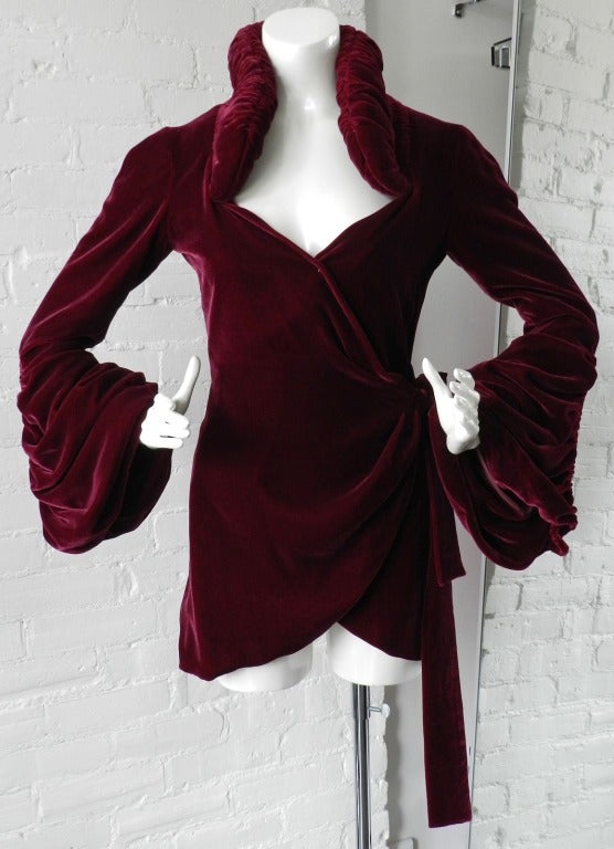 Norma Kamali deep wine color velvet jacket. Dramatic Art Deco 1930's inspired design with wrap front, side sash, ruched bell sleeves, and stand up collar. Excellent condition. Tagged size USA 4. Sleeves 24