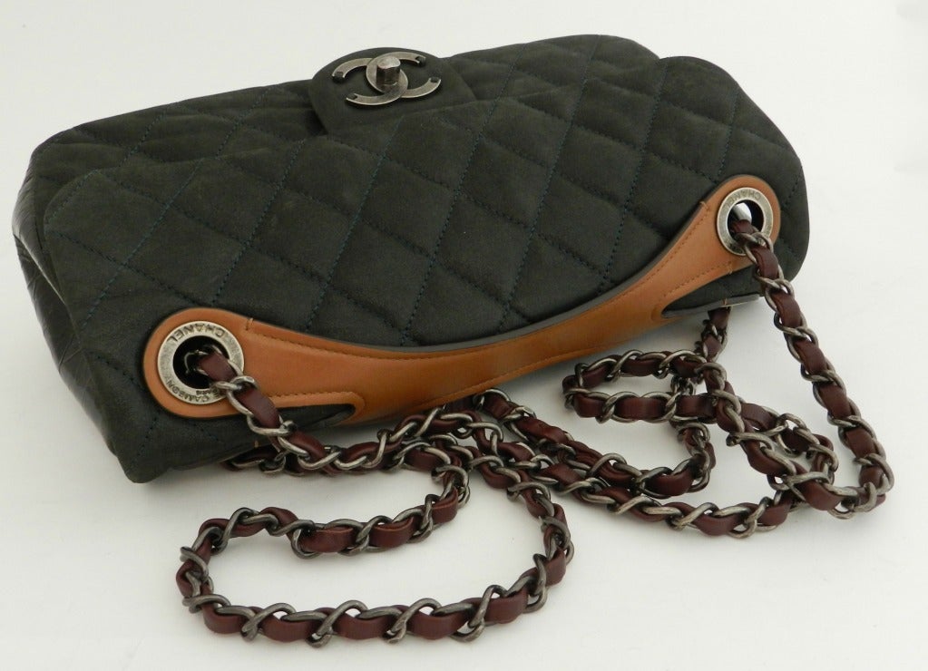 Chanel flap bag in dark blackish green, tan, and burgundy. Gunmetal grey hardware. Excellent previously owned condition. Has all cards and original store tag. No duster. Body of purse measures 10.5