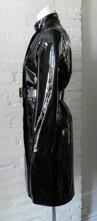 Yves Saint Laurent Rive Gauche black shiny patent leather long belted coat. Interior is lined with animal print patterned silk. Excellent previously owned condition - worn once if at all.  Tagged size 38.  Shoulder to shoulder 15