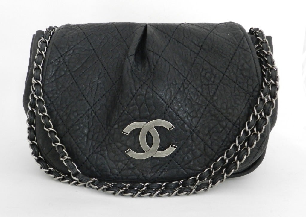 Chanel black purse with dark gunmetal grey color metal hardware. Double chain can be extended to single chain and worn cross-body. Excellent condition. Body of purse measures 12 x 9 x 5