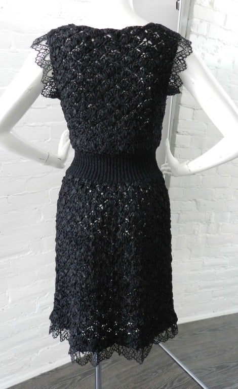 Chanel 2008 Spring black crochet knit dress with lace trim and jewelled black enamel buttons.  Knit stretch ribbed waist, sheer body.  Excellent previously owned condition. Tagged Chanel size 38.  100% silk.  Flexible sizing due to knit but good for