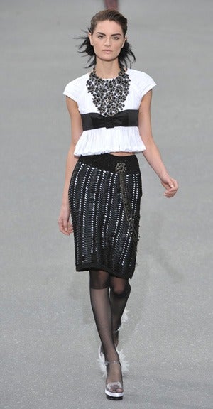 Chanel 2009 Spring runway skirt. Made of black woven knit ribbon, side zipper, and lined in white.  Excellent condition - worn once if at all. Tagged size 38.  28