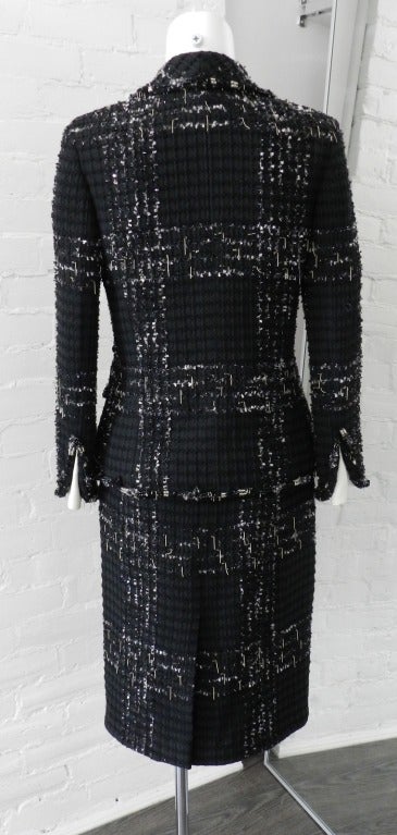 Chanel 2008 C black tweed skirt suit with white and silver tufts and silver metallic chain drops.  White satin peek a boo cuffs and decorated with black and clear glass beads.  Excellent condition - worn once.  Tagged size Chanel 36. Skirt waist