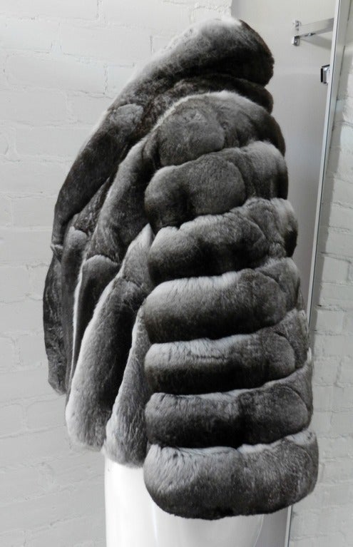 Christian Dior chinchilla fur short jacket. Grey satin lining, excellent condition.  Front is worn open with no closures, and it is a capelet design with short sleeves for arms.  Size tag is removed but is a size FR 38 or USA 6.  Should fit a size
