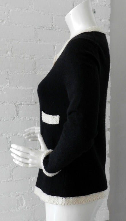 Chanel 03C black and off-white cashmere cardigan sweater. Closes with clear invisible snaps at front.  Tagged Chanel size 40 (USA 8).  To fit 36/38