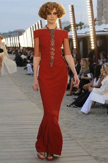 Chanel 2010 resort runway collection red wool long gown.  Sheer net sleeves and gold metallic trim. Excellent condition.  Tagged Chanel size 38 (USA 6).  To fit 34/35