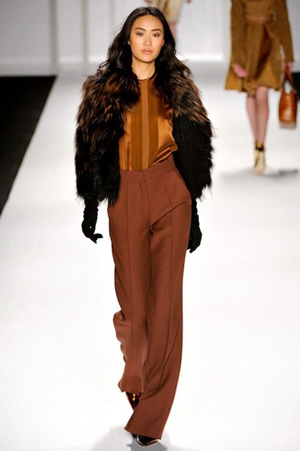 Rust and black fox fur jacket by J. Mendel. 2012 fall runway piece. Excellent condition - worn once. Light-weight and flowing. Suitable as an evening cocktail jacket. Fox fur tufts on a light sheer net base and lined in black silk.  Tagged size USA
