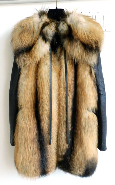 J. Mendel red fox fur coat with removable leather sleeves. Converts into vest.  Light fall-weight so not a heavy winter coat. Leather sleeves have stretch and snap on an off. Sides of vest have slits up to the waist and there is a black leather