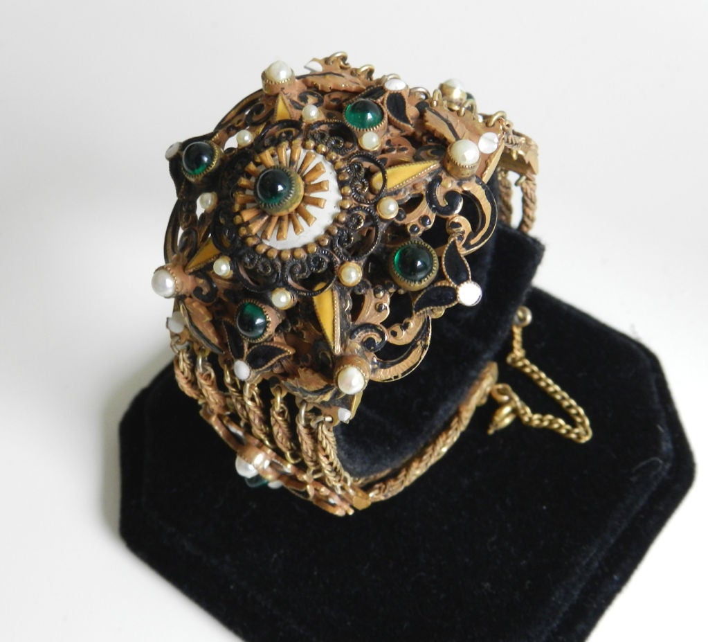 Vintage collectible Hobe designer bracelet. Austro-Hungarian revival design.  Antiqued goldtone metal with faux pearls, enamel, and green glass cabochons.  Ornate reverse, signed Hobe on clasp, and original safety chain. Mesaures 6.75
