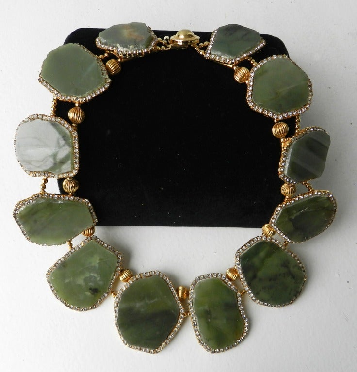 Vintage 1970's William DeLillo green quartz polished stone bib necklace. Set in goldtone metal with beaded spacers and clear rhinestones. Reverse of clasp is marked De Lillo.

Shipping prices provided are for FedEx Ground to the USA. For quotes on