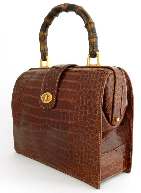 Gucci rich cognac color alligator bag with bamboo handle. Suede lined. Excellent clean condition. Matte goldtone hardware. Body of purse measures 10.5 x 8 x 3.75 inches not including handle.

Shipping costs provided are for FedEx Ground to the USA